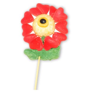 Fleur en bonbons sur boule coco – pétales cœur rouges, centre œil, feuilles gélifiées vertes